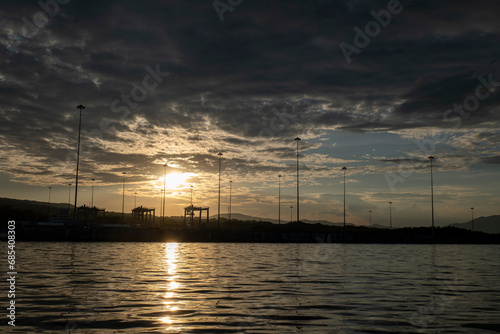 Obraz na płótnie Dramatic Sky with Silhouettes of Poles, Sunset in the Port of La Union in Salvador w salonie