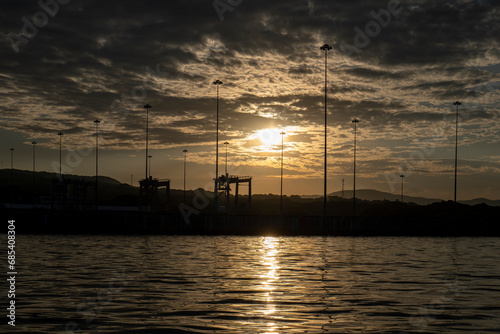 Obraz na płótnie Golden Dramatic Sky with Silhouettes of Poles, Sunset in the Port of La Union in Salvador w salonie