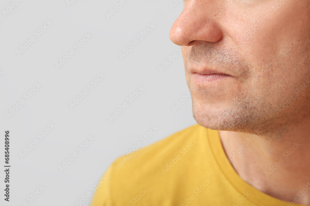 Fototapeta premium Mature man on grey background, closeup