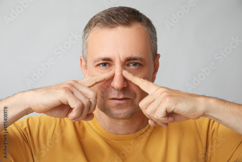 Ill mature man pointing at ...