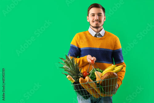 Young man with shopping bas...