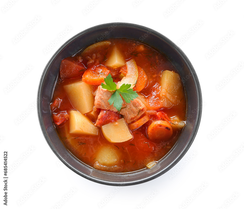 Black bowl with delicious beef stew and parsley on white background Black bowl with delicious beef stew and parsley on white background