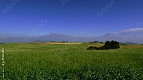 View of the Popocatepetl volcanoes launching fumarole and Iztaccihuatl from the countryside south of Mexico City.