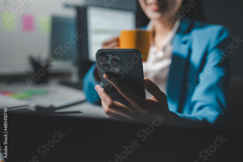 Beautiful woman in the office, happy, businesswoman uses internet phone close up, businesswoman checks email on smartphone, manager uses mobile phone, women in suit writes message on smartphone