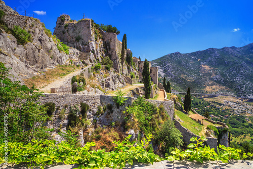 Summer landscape - view of the ruins of the Klis Fortress, near Split on the Adriatic coast of Croatia photo