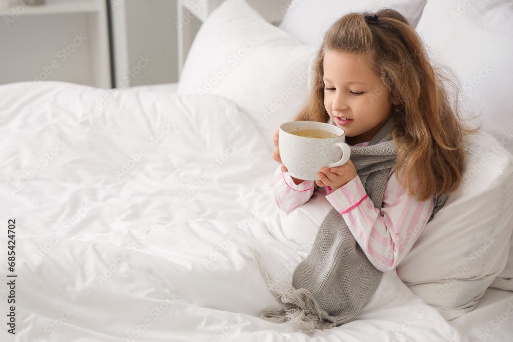 Sick little girl drinking hot tea in bedroom Sick little girl drinking hot tea in bedroom