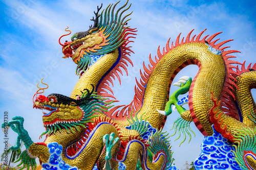 Golden dragon statue with blue sky
