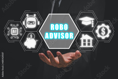 Robo advisor concept, Businessman hand holding robo advisor icon on virtual screen. photo