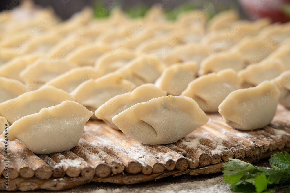 making dumplings in the kitchen. traditional food raw dimplings making dumplings in the kitchen. traditional food raw dimplings