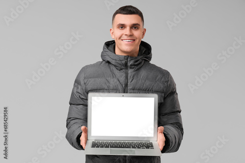Young man in stylish puffer...