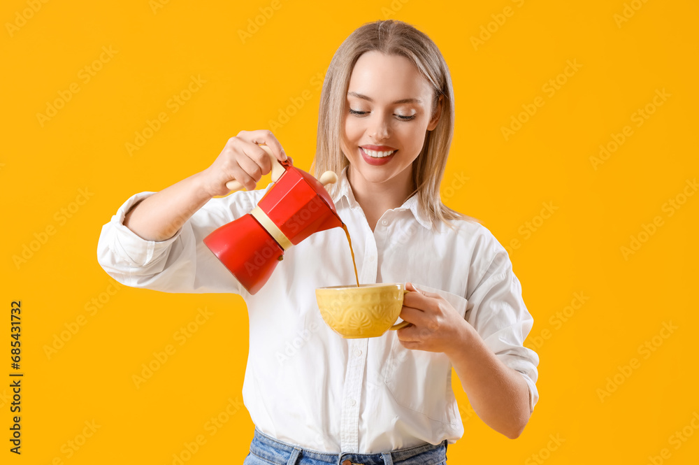 Pretty young woman pouring espresso from geyser coffee maker into cup on yellow background Pretty young woman pouring espresso from geyser coffee maker into cup on yellow background