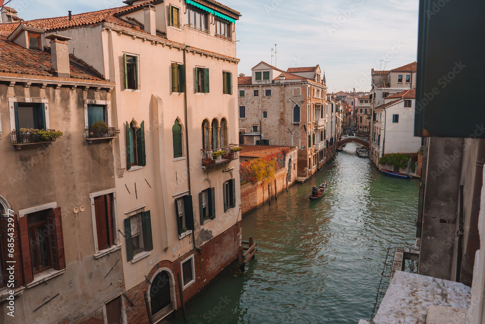 Experience the timeless allure of Venice with this stunning view of the iconic canals and gondolas, showcasing the city's romantic and picturesque atmosphere.