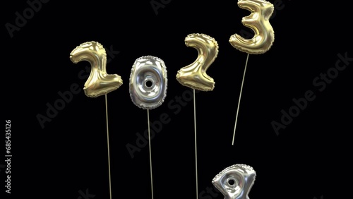 colored new year mylar balloon writing 2023 with the 3 flying away and 4 floating up to form 2024 gold and sylve
 photo