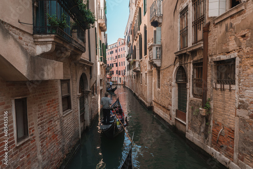 A serene gondola ride through the picturesque canals of Venice, showcasing the charming architecture and timeless beauty of the iconic waterways. Experience the enchanting old-world charm of Venice.