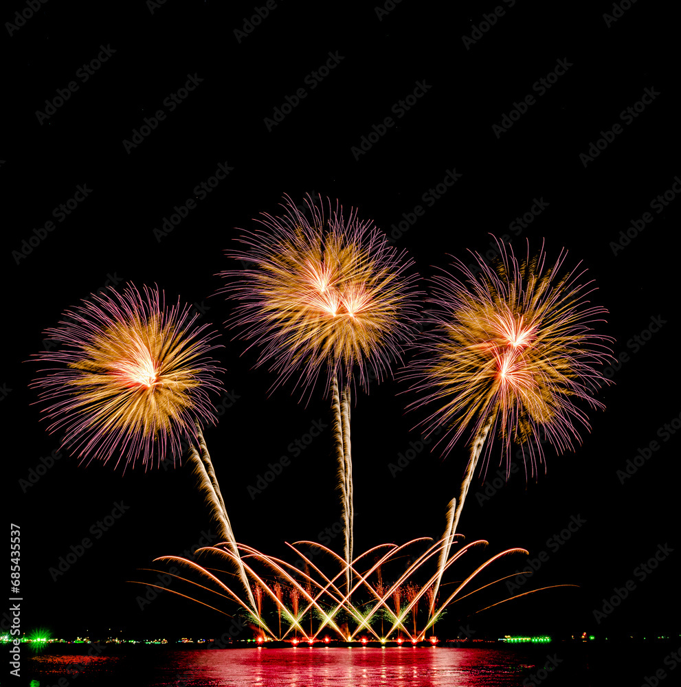 Fireworks show under defocus or blur concepts with isolated black background at night, this celebration is for the International Fireworks Festival in Pattaya on Nov 24-25 in Thailand.