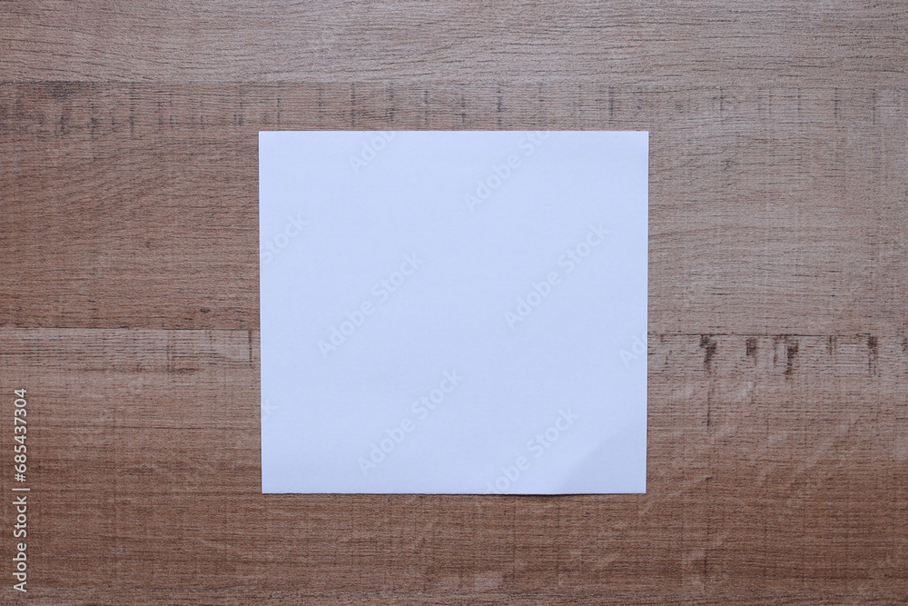 White blank empty paper for mock up on wooden background White blank empty paper for mock up on wooden background