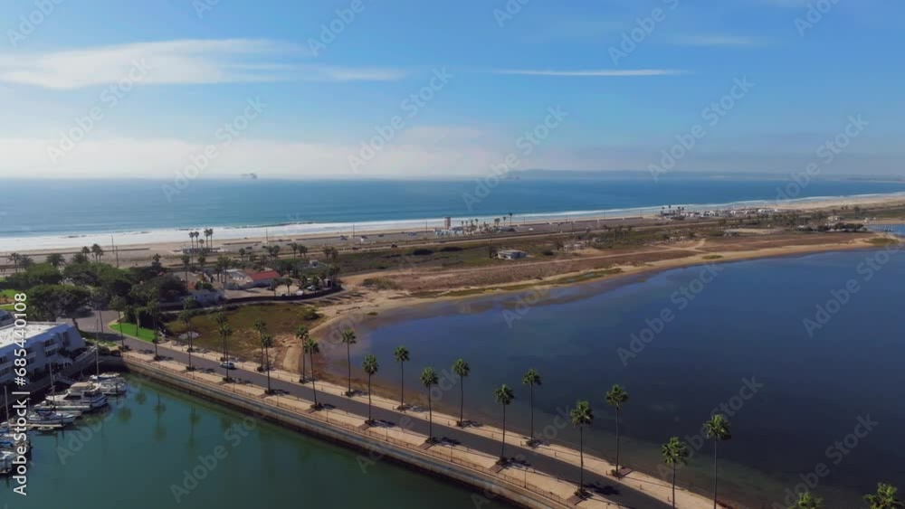 Coronado Bay Road With Palm Trees Near The Silver Strand State Beach In Coronado, California, USA. - aerial shot Coronado Bay Road With Palm Trees Near The Silver Strand State Beach In Coronado, California, USA. - aerial shot