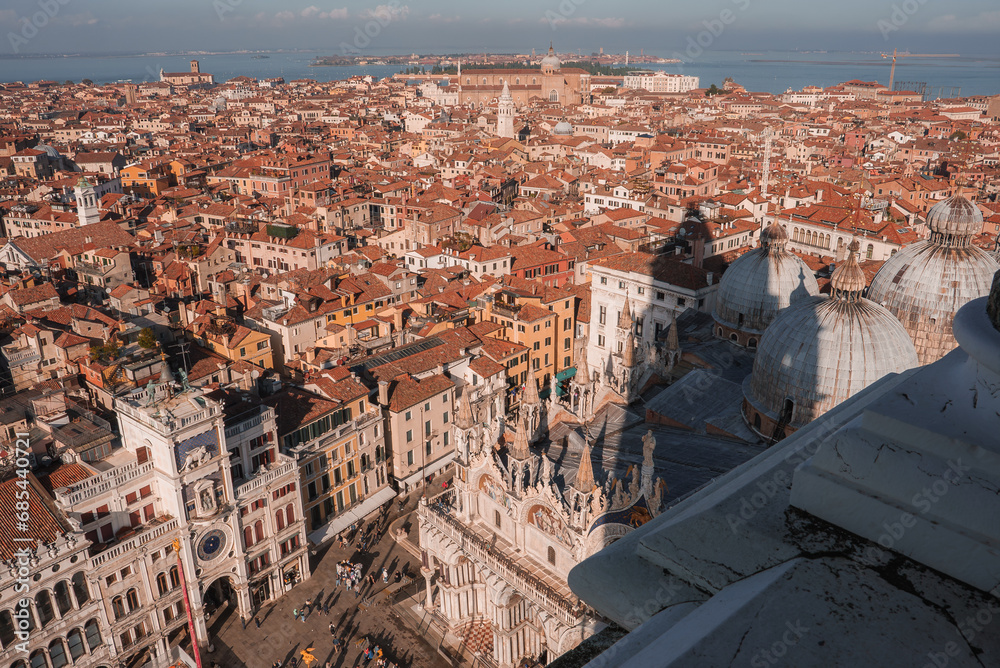 Aerial view of Venice cityscape, evoking serenity and tranquility. The image showcases the unique layout, iconic canals, and historic architecture, capturing the essence of Venice during the summer.