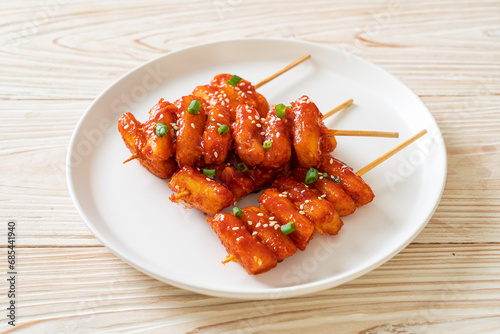 deep fried Korean rice cake (Tteokbokki) skewered with spicy sauce photo