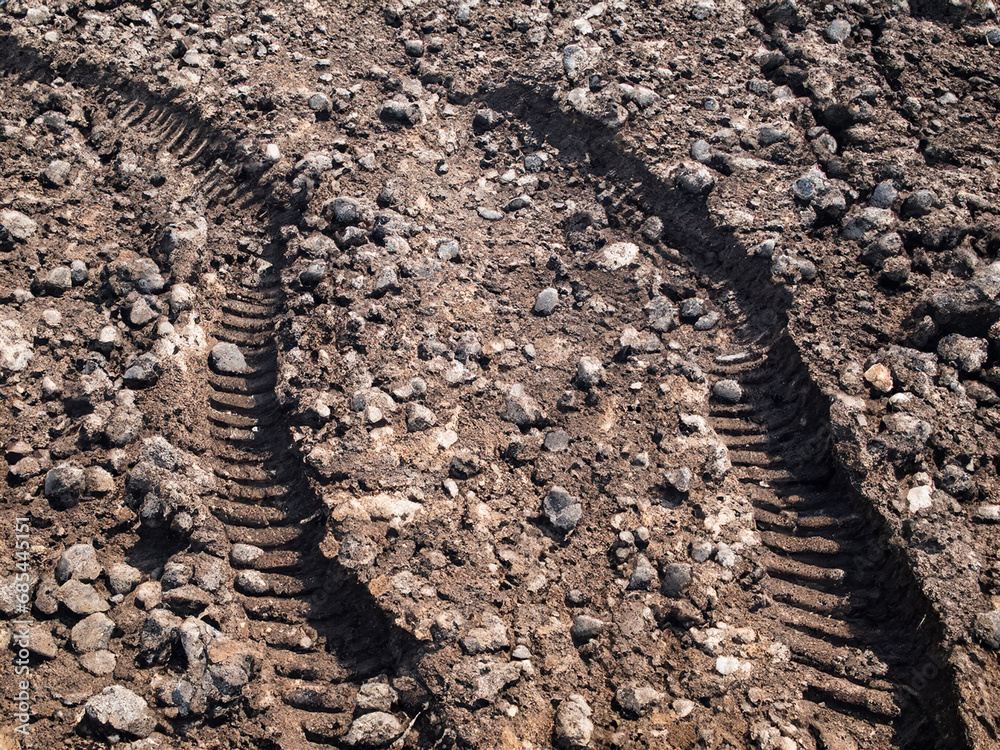soil with stone and tractor wheel track soil with stone and tractor wheel track