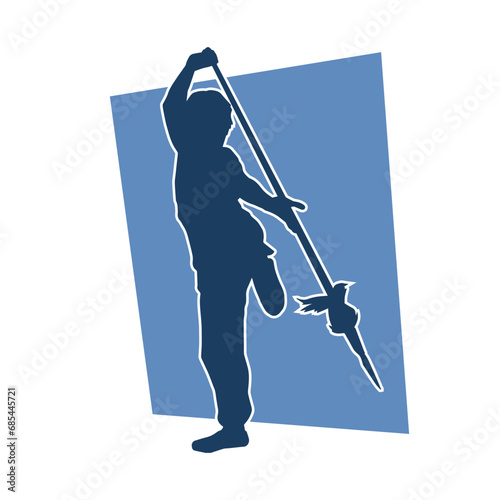 Silhouette of a female warrior carrying spear weapon. Silhouette of a female fighter in action pose.