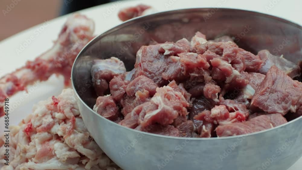 Raw mutton in metall bowl close-up. Muttons meat for uzbek pilaf. Turkey food. Chef preparing a bif piece of fresh raw meat Raw mutton in metall bowl close-up. Muttons meat for uzbek pilaf. Turkey food. Chef preparing a bif piece of fresh raw meat