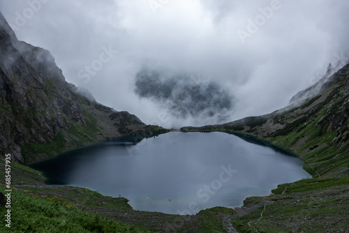 Lake Czarny Staw pod Rysami with clouds on rainy day. Tatra National Park  Poland.
