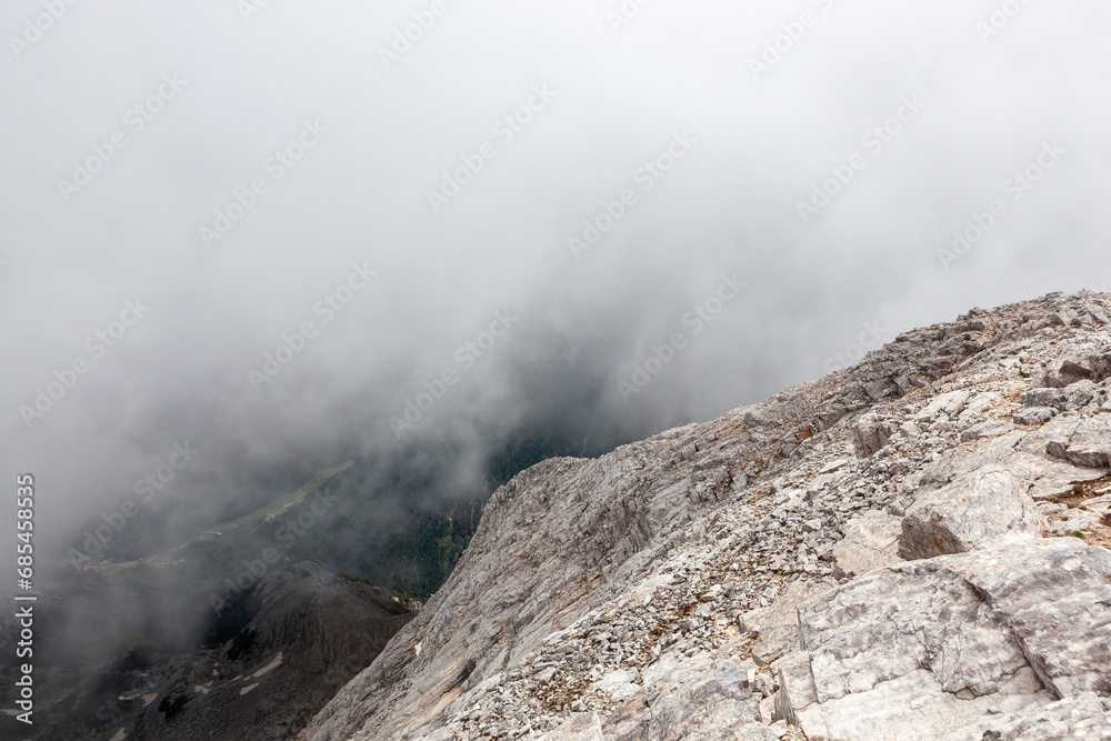 Cloudy view from rocky mountain summit. Vihren peak in Bulgaria.