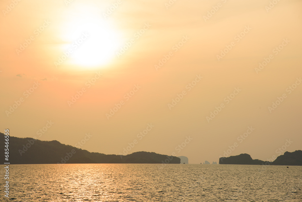 Landscape with sunset at the seashore. sunset sea rock horizon view. Sea rock sunset silhouette. Sunset sea rock and mountain range. Nature background