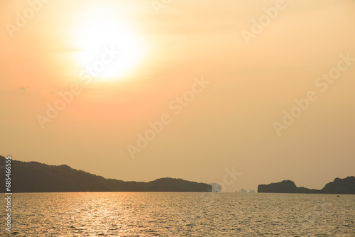 Fototapeta Naklejka Na Ścianę i Meble -  Landscape with sunset at the seashore. sunset sea rock horizon view. Sea rock sunset silhouette. Sunset sea rock and mountain range. Nature background