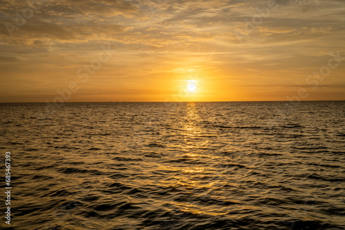 golden sunrise over Tampa Bay in Florida with some waves