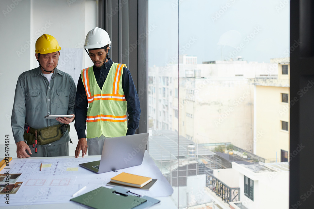 Team of construction workers having video call with foreman Team of construction workers having video call with foreman