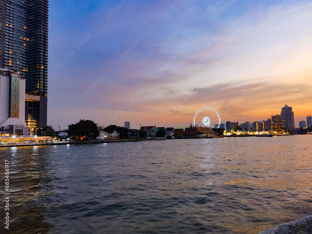 Bangkok, Thailand: Beautiful Landscape of high modern building tower at Chaopraya river in evening with colorful sky at Asiatique The Riverfront travel
