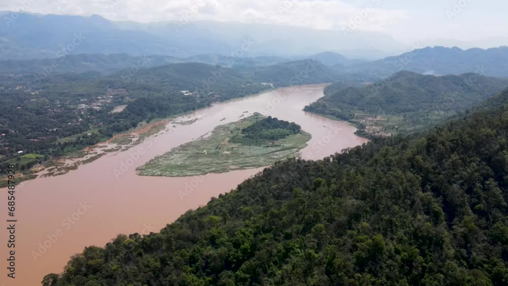 Aerial Flying Over Tropical Forest Hill With View Of Mekong River. Dolly Right Shot Aerial Flying Over Tropical Forest Hill With View Of Mekong River. Dolly Right Shot