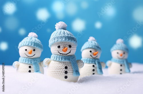 Knitted snowmen in hats and scarves, it's snowing © upssallaaa