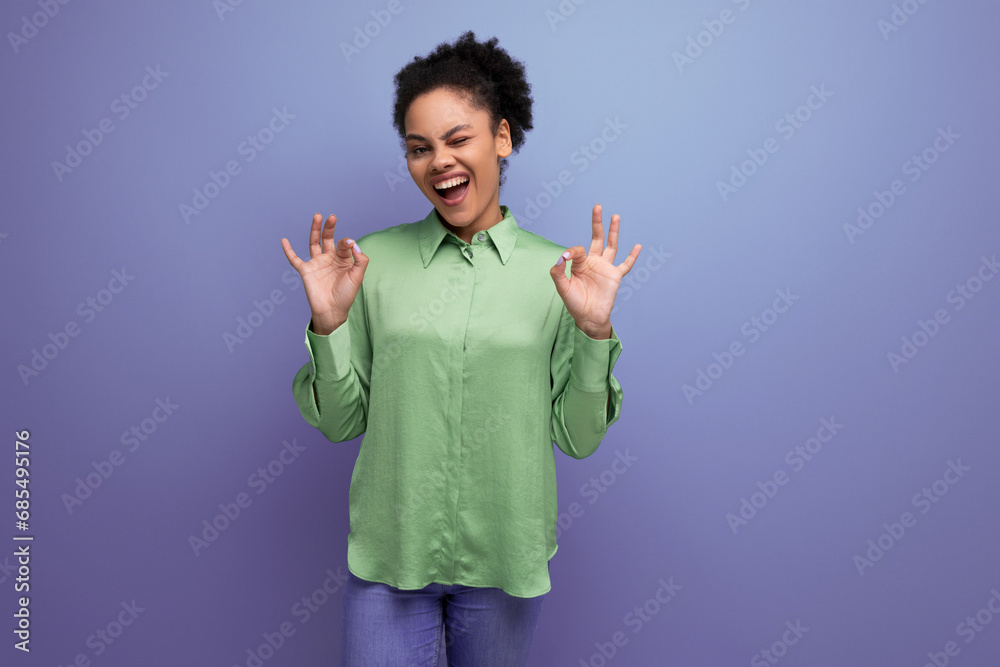 young bright cheerful latin woman dressed in a green blouse on the background with copy space young bright cheerful latin woman dressed in a green blouse on the background with copy space