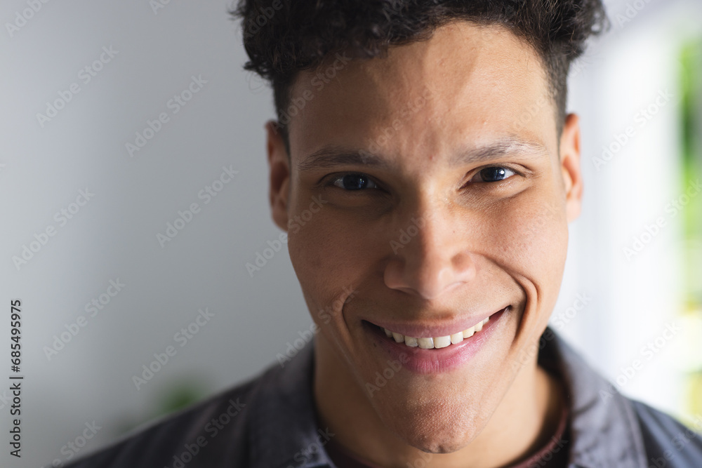 Obraz premium Portrait of happy biracial man in living room at home, copy space