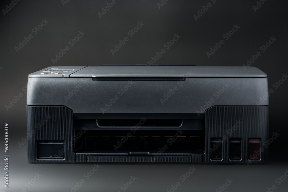Modern laser printer on black background close up Modern laser printer on black background close up