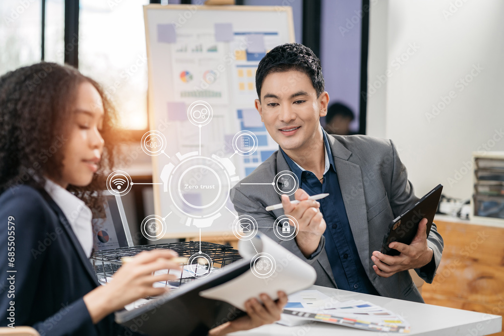 Zero trust security concept Person using computer and tablet with zero trust icon on virtual screen of Data businesses.in office. Zero trust security concept Person using computer and tablet with zero trust icon on virtual screen of Data businesses.in office.