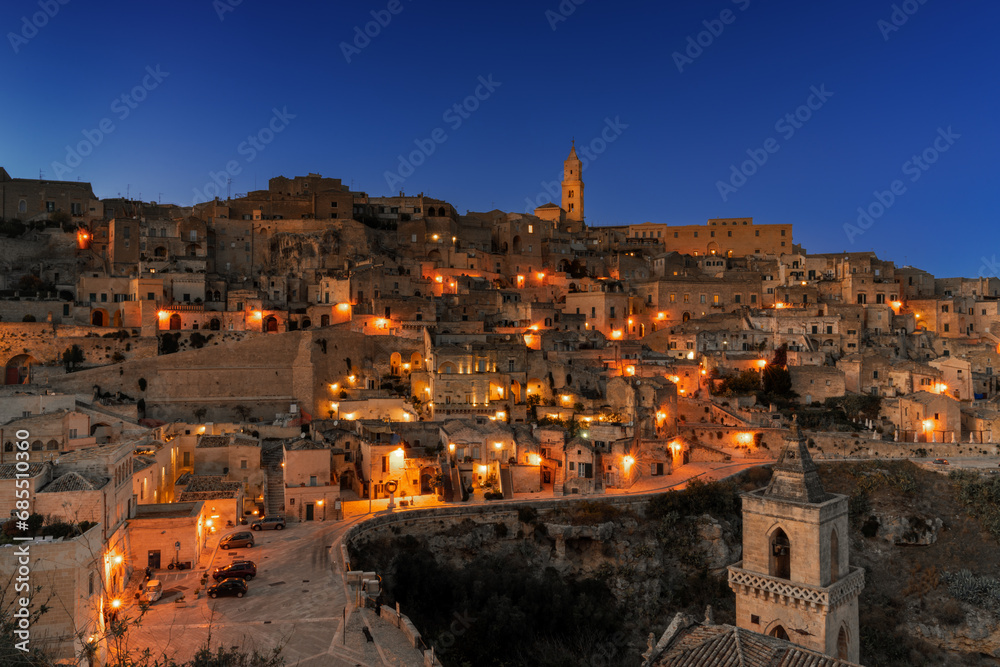 view of the old town of Matera after sunset with the lights coming on