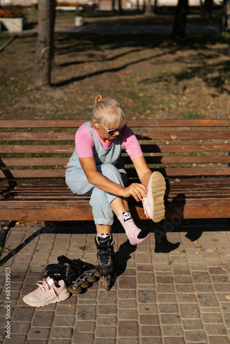 Photography Middle-aged woman roller-skates in the city