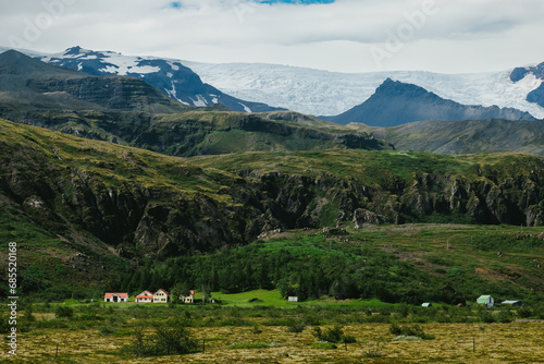 Small farms and homesteads under mountains and glaciers