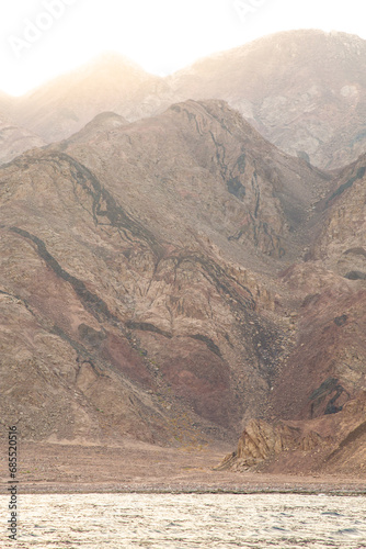 Mountain range next to calm sea during golden hour, Dahab