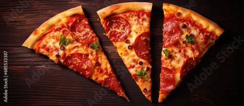 View of three hot and delicious pizza slices from above