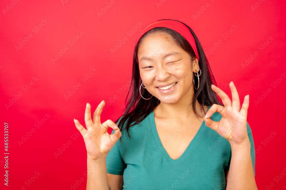 Cute chinese woman winking and gesturing perfection Cute chinese woman winking and gesturing perfection