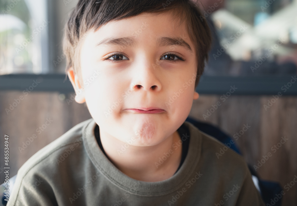 Photo of funky happy cheerful young little boy make funny face, Portrait of good mood a preschool kid making fun with lips looking at camera on blurred background Photo of funky happy cheerful young little boy make funny face, Portrait of good mood a preschool kid making fun with lips looking at camera on blurred background