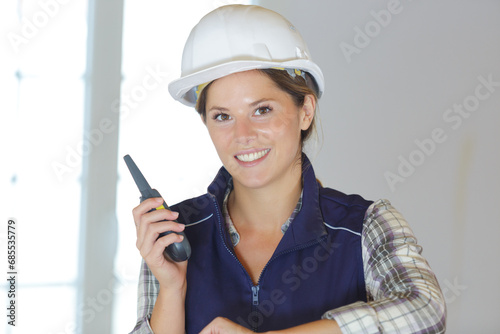 portrait of female builder holding a walkie talkie