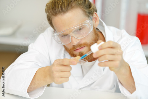 lab technician working with pipette in molecular laboratory