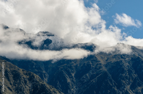 Panorama of the Andes Mountains in the Colca Canyon, Peru. White clouds and blue sky.