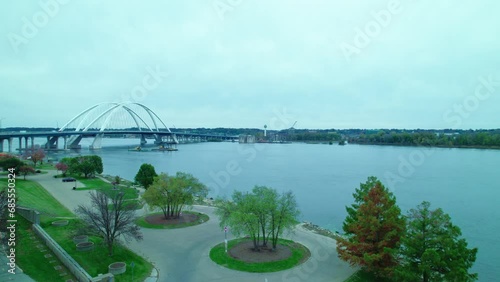 Two Excavators on floating dock pontoon on mississippi river at Centennial Bridge in Davenport, Iowa, USA. Aerial view photo